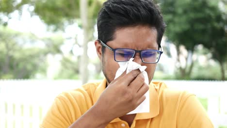 portrait of sick man sneezes and coughs,