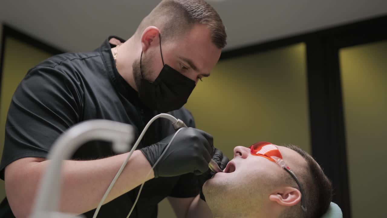 Dentist Performing Dental Procedure on Patient