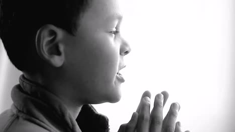 boy praying to god with hands held together with people sock footage stock video