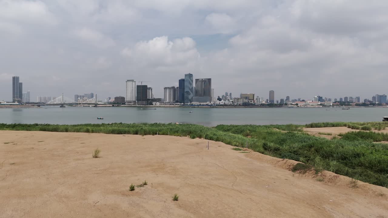 Aerial drone footage above a huge sand area in front of the islands of Koh Pich and Koh Norea in Phnom Penh. New constructions, buildings and homes will start soon