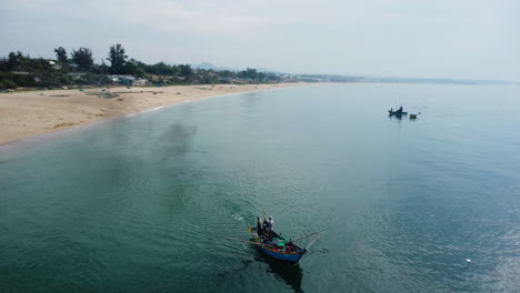 Unrecognizable-fisherman-operating-boat-with-fishing-net,-Vietnam