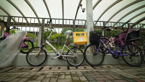 bicycles locked on a metal fence at the entrance, revealing shot