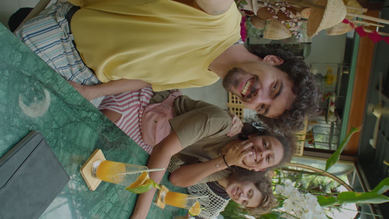Cheerful Friends Posing for Camera in Outdoor Cafe