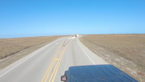 POV-while-driving-on-paved-paved-road-thru-the-park-ranger's-station-at-North-Padre-National-Seashore