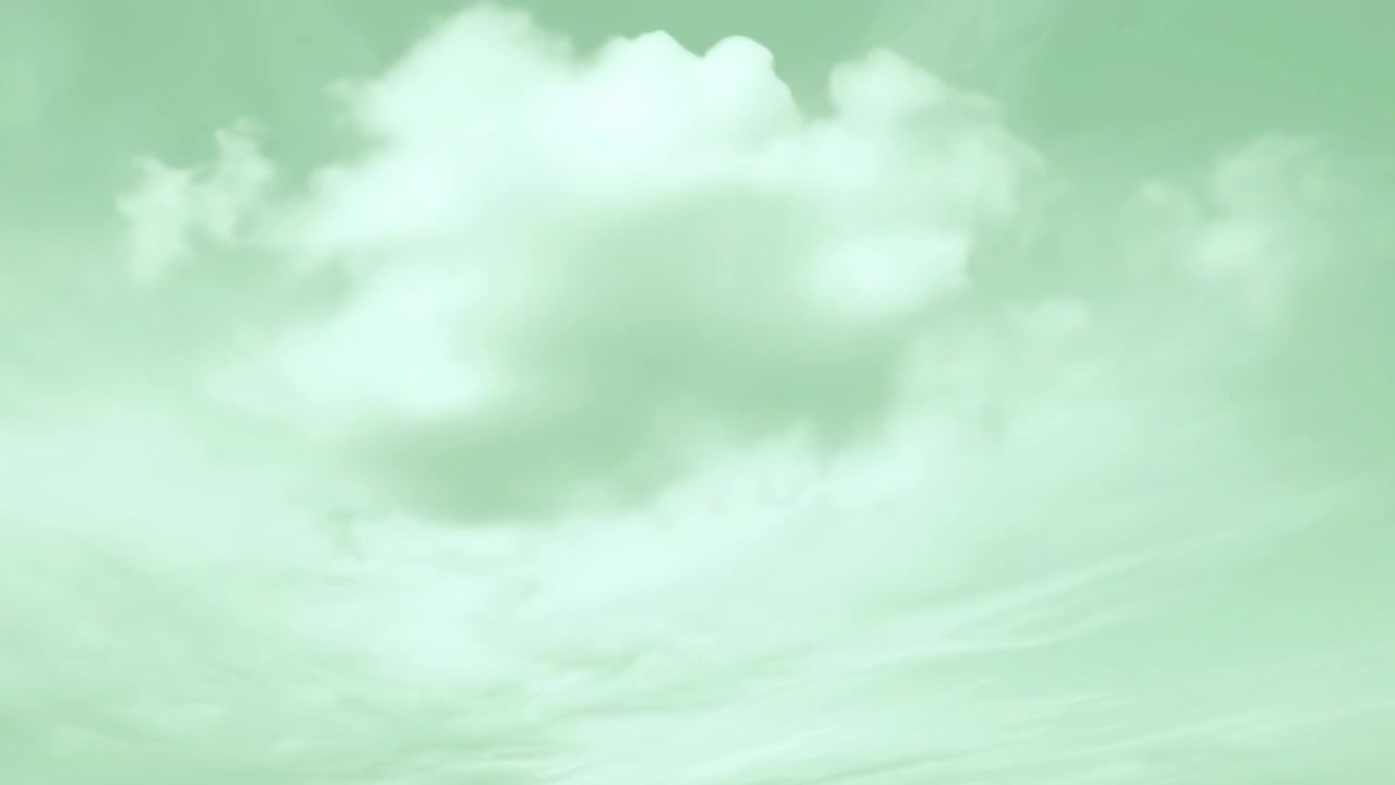 Time Lapse of White Clouds Moving Across a Green Sky