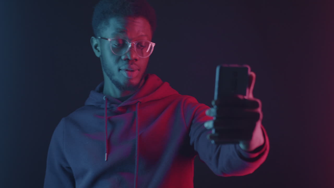 Man Taking a Selfie in Neon Light