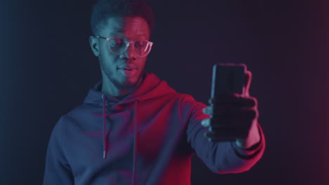 man taking a selfie in neon light