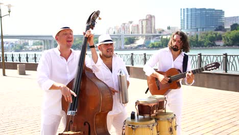 trio of musicians perform at a street concert