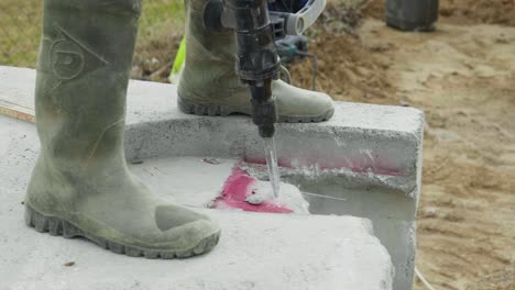 male worker builder uses electric impact drill in slow motion