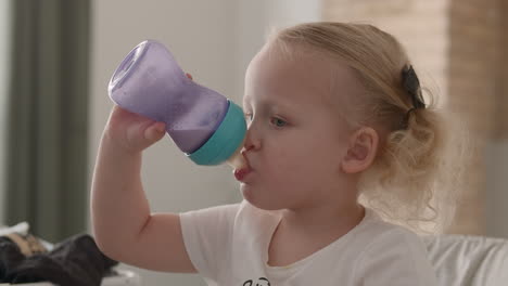 little child drinking milk from the bottle