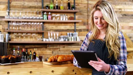 waitress using digital tablet at counter