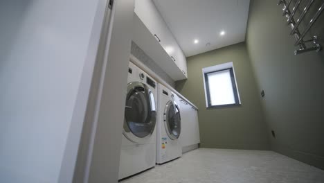 washing machine with clothing inside a drum during cleaning and washing.laundry room interior.