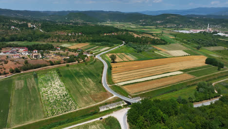 Drone-shot-tilting-toward-rural-fields-on-the-countryside-of-Istria,-Croatia