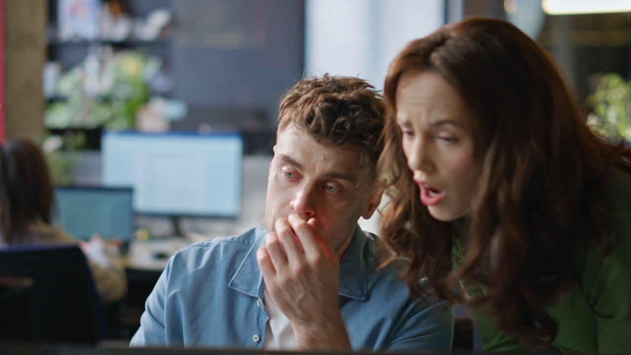 Worried managers analyzing office work closeup. Serious colleagues looking tab