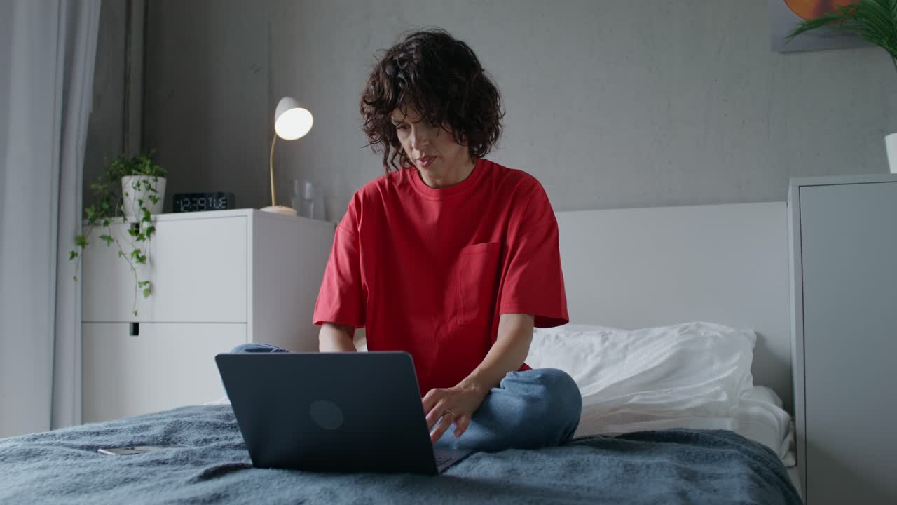 Woman Working on Laptop on Bed