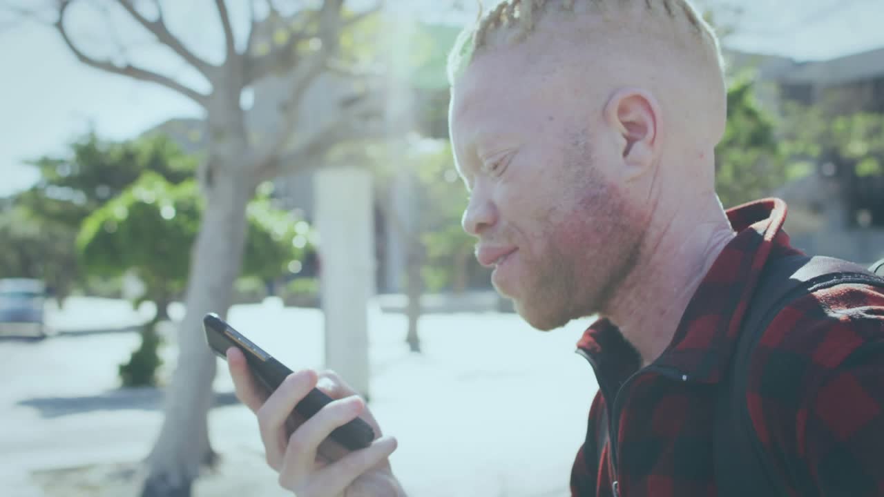 Man checking phone in sunlit plaza, VIBES overlay appearing, lifting phone, speaking, showing tech