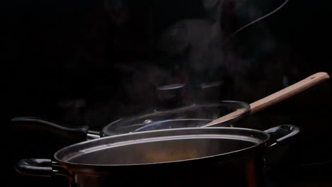 cassava is being boiled in a pot of boiling water to making thai dessert, cassava root with coconut milk or singkong rebus, traditional indonesian food.