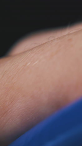 young man plays with new ball pen in transparent case on blurred background extreme close view