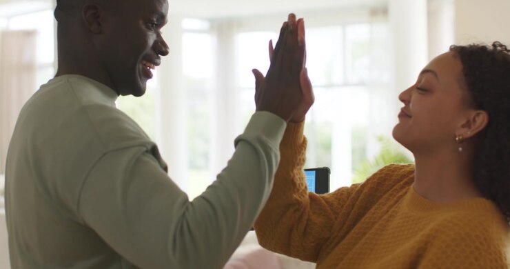 African American couple watching man tapping tablet, starting demo blue smart home UI, high-fiving