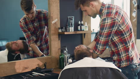 barber giving a haircut and shaving