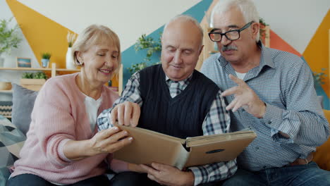 elderly people sharing memories from a photo album