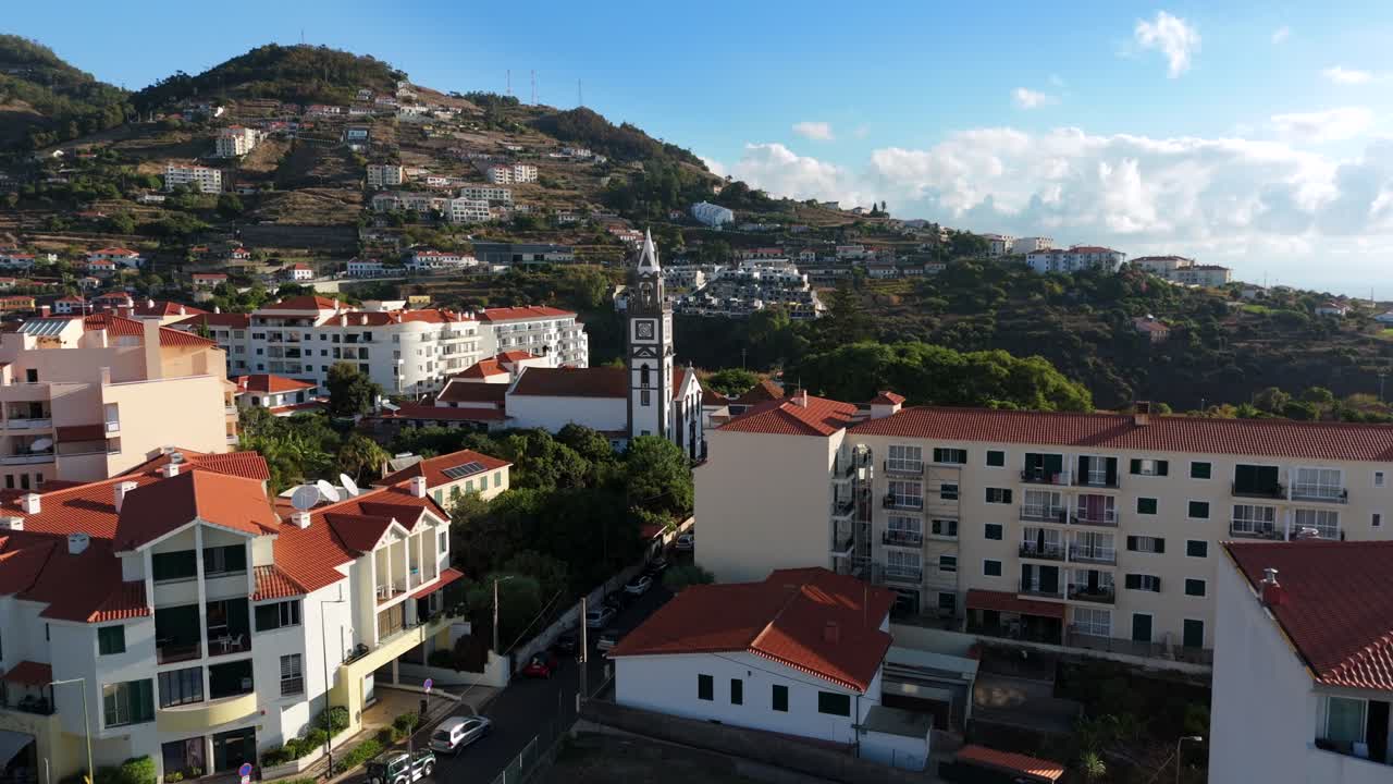 Hyperlapse drone shot Canico parish church over rural coastal town in Madeira