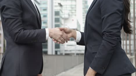 mid section of businesswomen shaking hands