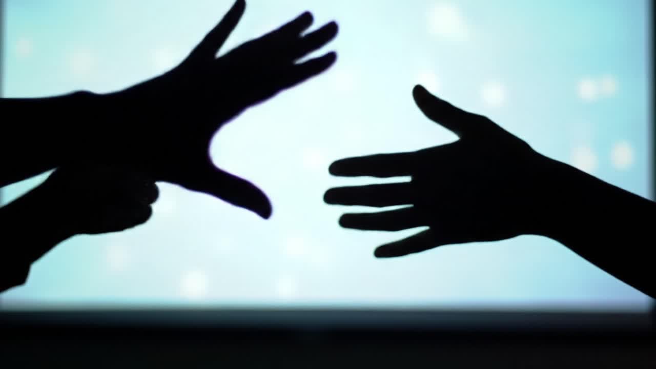 The Dance of Connection: Silhouetted Hands Reaching Out Across a Dreamlike Blue Background, Evoking Emotions of Touch and Desire for Connection