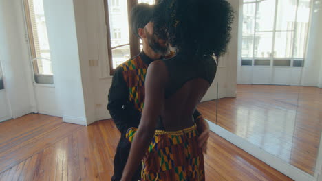 partners meeting in studio, kissing and dancing tango