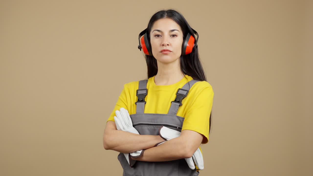 Serious Woman Constructor in Safety Gear with Folded Arms