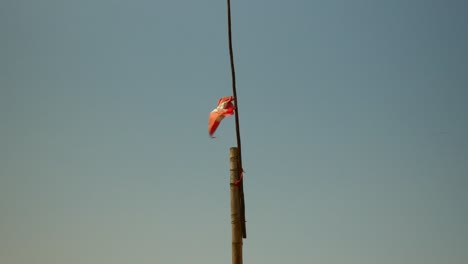 a tattered peruvian flag waving in the wind