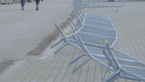 crowd control barriers fallen on the ground due to strong wind