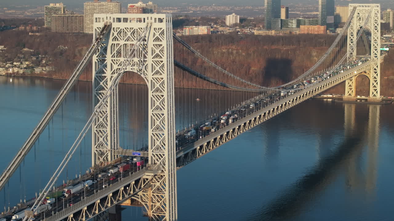 Aerial view of rush hour traffic crossing New York City’s George Washington Bridge. Shot at sunrise.