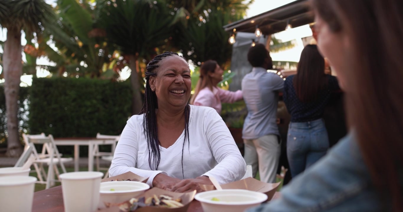 Happy African American Woman Laughing at Outdoor Food Truck Event