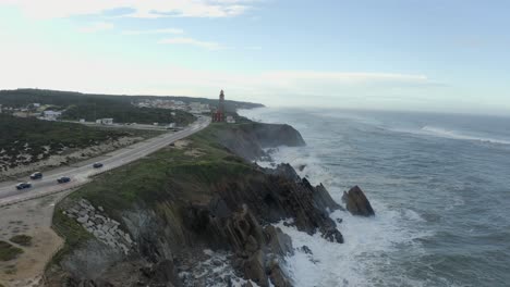 Drone-flying-over-rocky-coast-with-big-waves-crashing-against-coastal-rock-formations