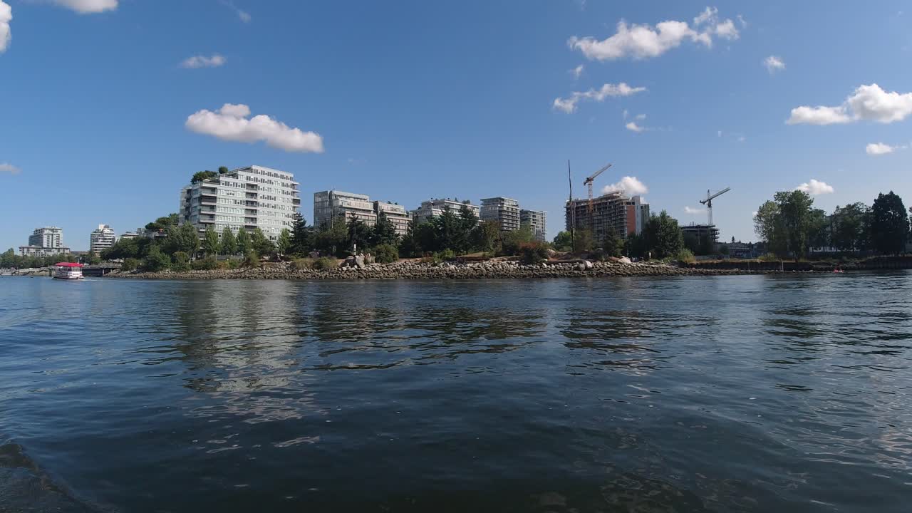 False Creek DT BC Canada Olympic Village harbor where Canadians relax on an inflatable boat sipping side by side consuming lots of alcohol despite COVID19 physical social physical distancing dingy1-7