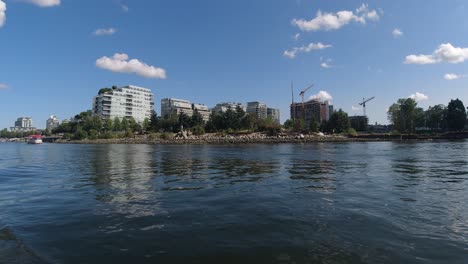 false creek dt bc canada olympic village harbor where canadians relax on an inflatable boat sipping side by side consuming lots of alcohol despite covid19 physical social physical distancing dingy1-7