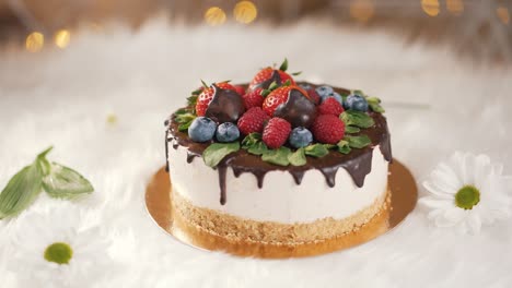 cake with chocolate drips and berries