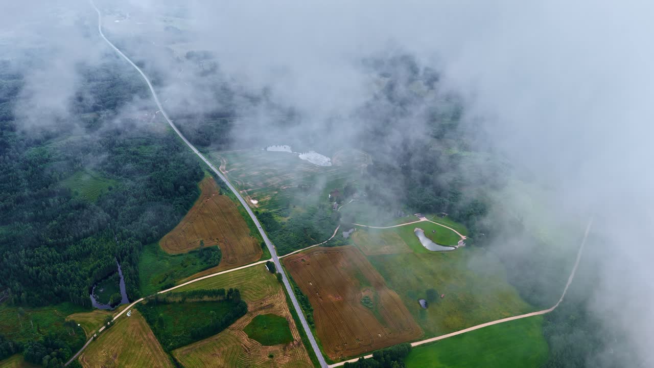 Agriculture land aerial drone above clouds rural countryside farmland farm village