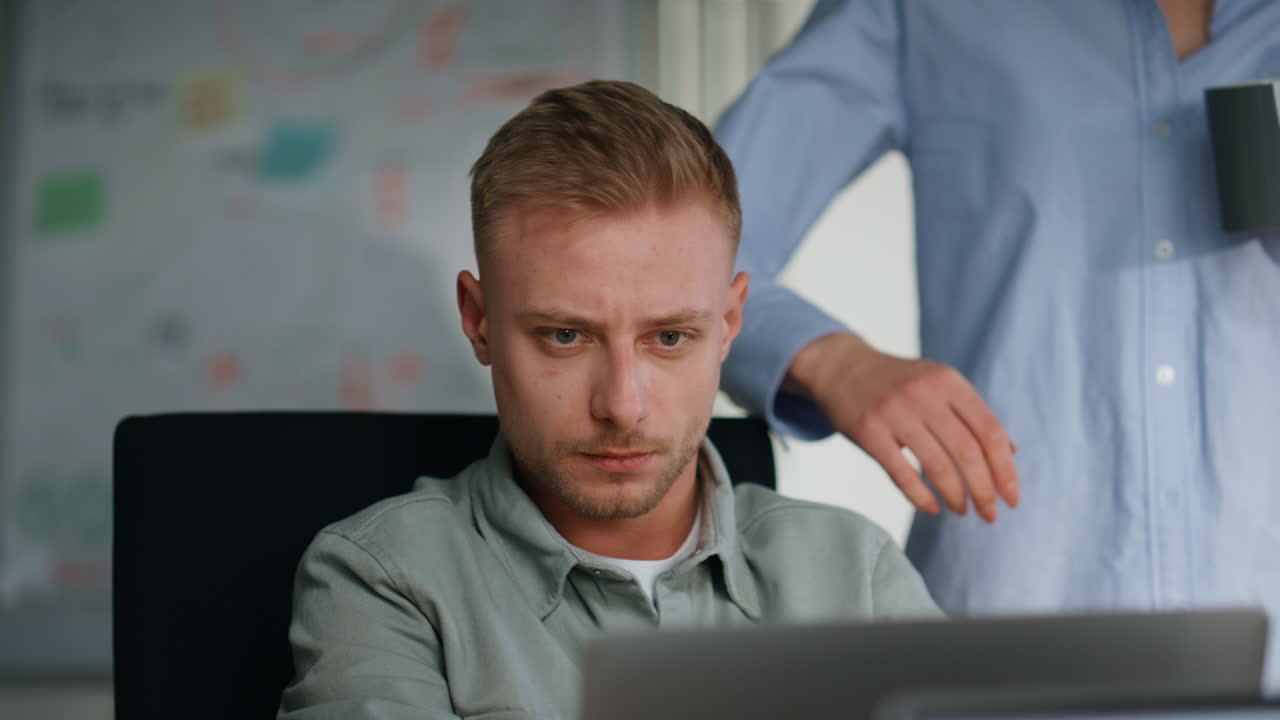 Woman trainer consulting colleague sitting with laptop at office close up.