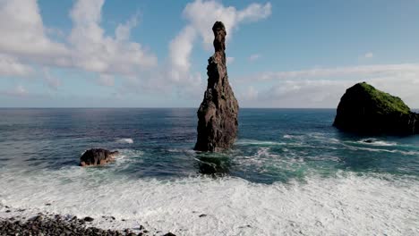 Aerial-of-photographer-taking-picture-of-coastal-rock-formation,-Madiera,-Portugal