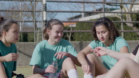 sporty teenager girls having rest after tiresome training