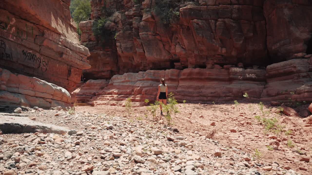 Young caucasian woman walking through a valley in Paradise Valley, Agadir, Morocco