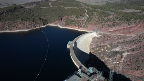 aerial view, hydroelectric dam, power plant and road passing by water reservoir