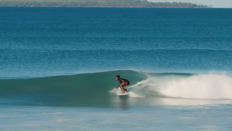a surfer rides a large wave in the ocean