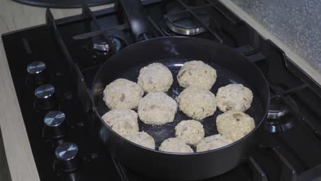 tofu cutlets are fried in hot oil in a pan, the camera moves around the pan