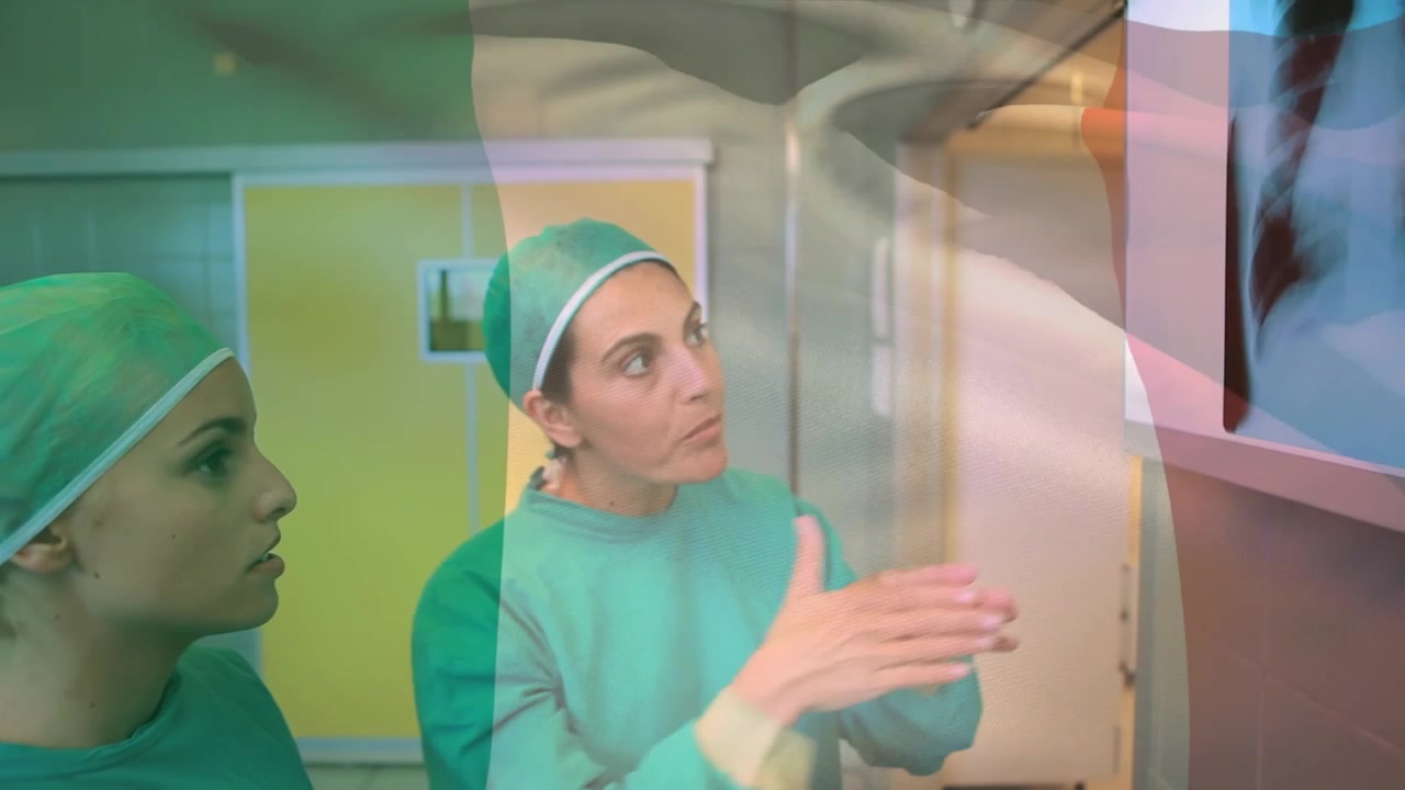 Animation of flag of nigeria over caucasian female doctors talking