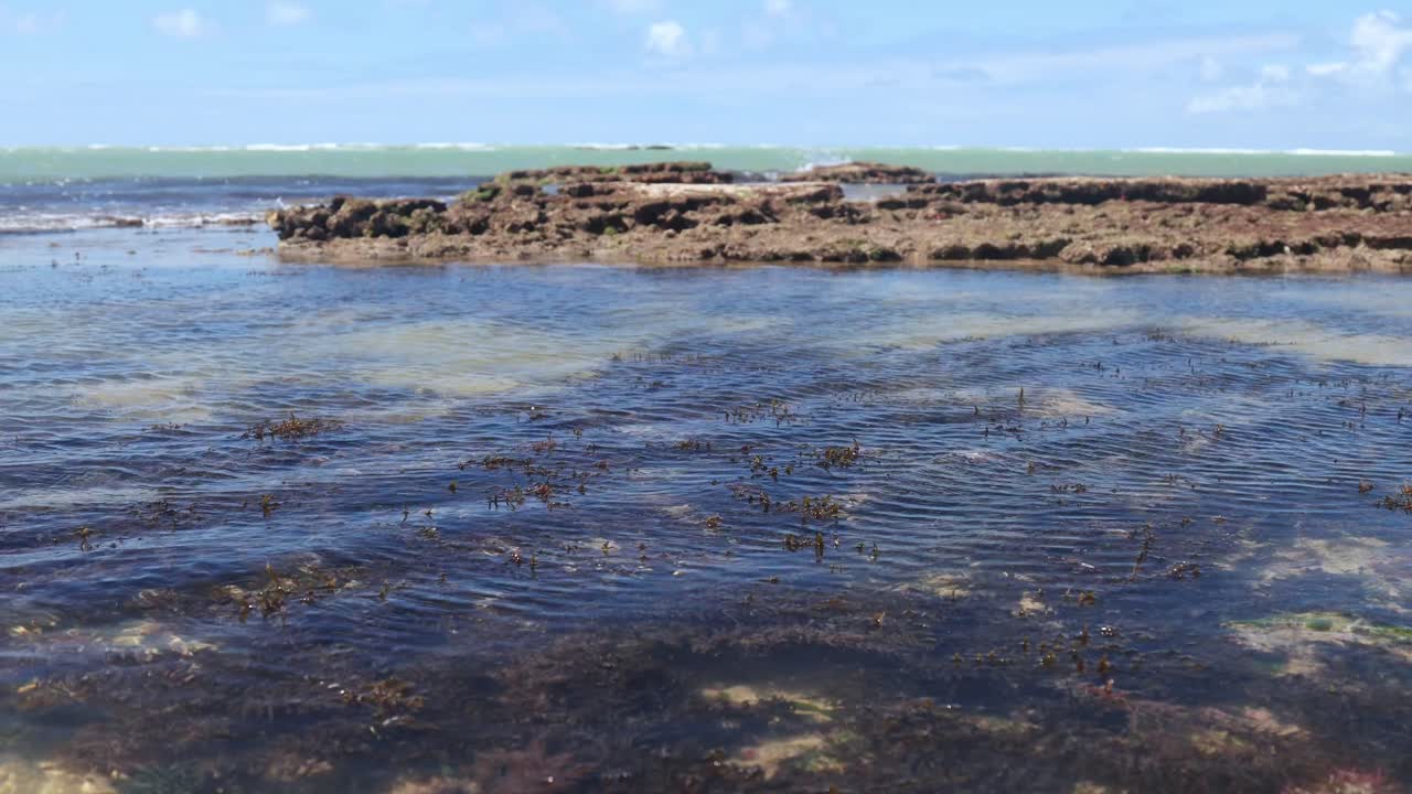 Time lapse of comes and goes of waters in natural pool on tropical beach, Brazil