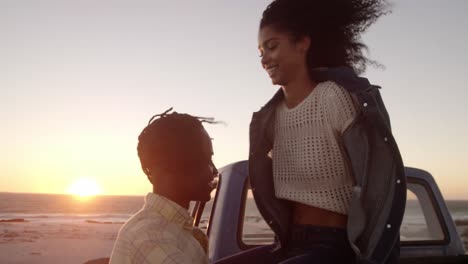 Couple-embracing-each-other-at-beach-during-sunset-4k