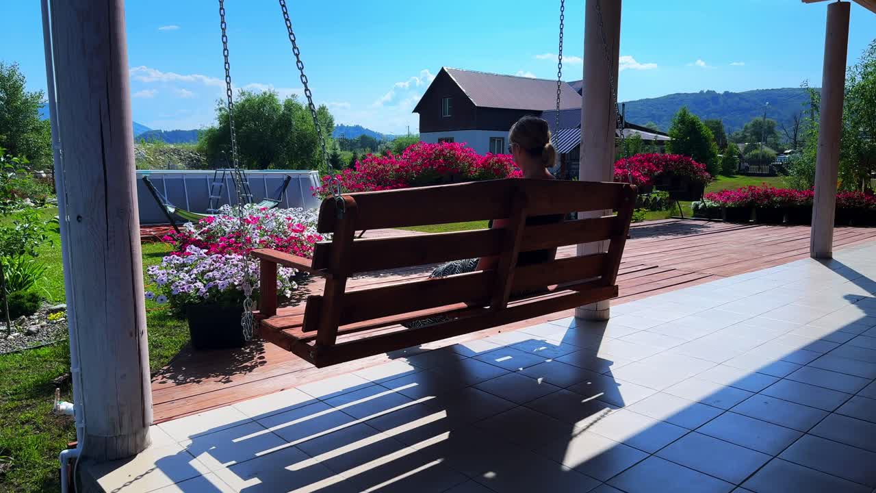 A Serene Afternoon on a Garden Swing, Embracing Nature's Beauty and Tranquility Amidst Colorful Blooms and Scenic Landscapes